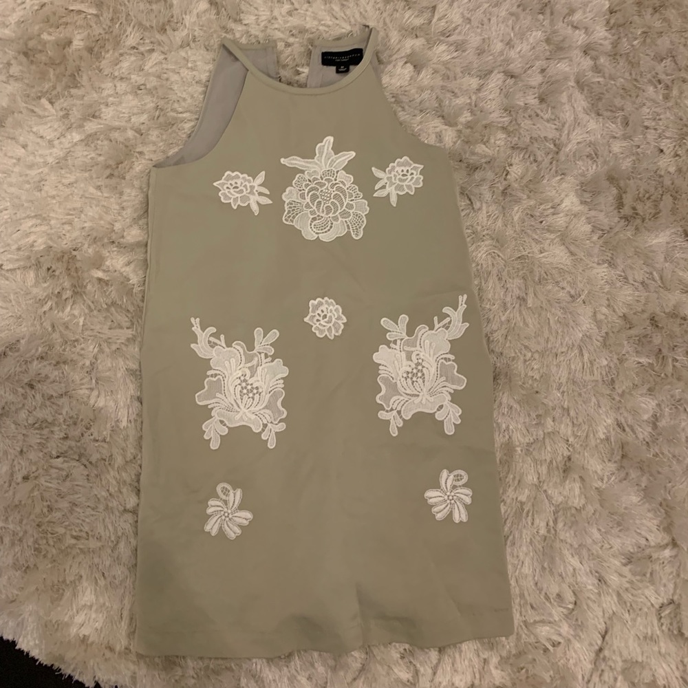 Green dress with white lace flowers.